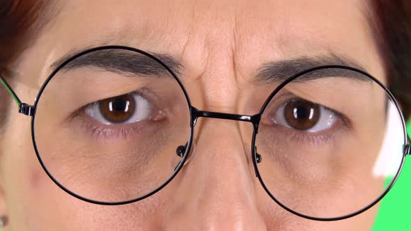 Offended Female Eyes in Round Glasses , Close Up