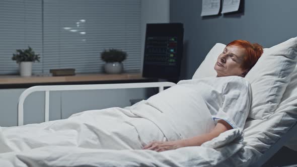 Mature Patient Napping in Hospital Bed