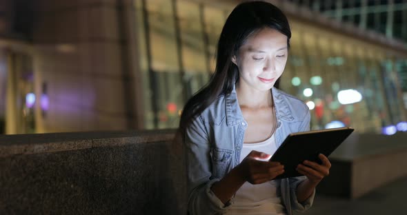 Woman use of digital tablet at night 