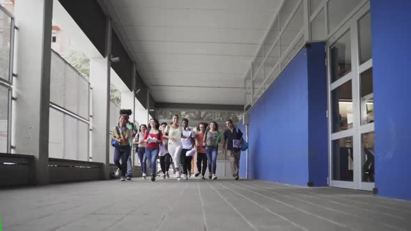 Multiethnic Group of Secondary School Students Running Together to Classes