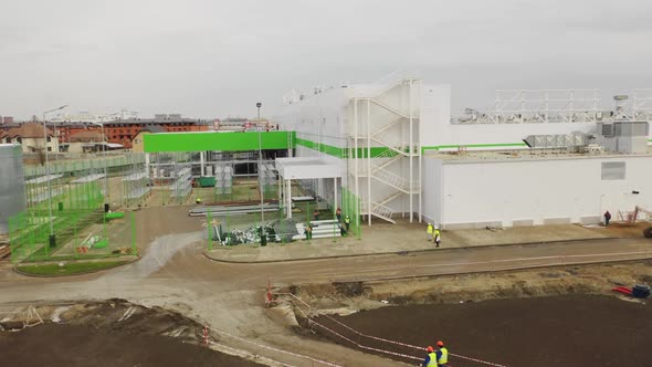 Workers Walk Along Store Construction Site Aerial View