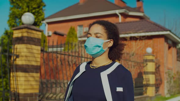 Black Woman in Medical Mask Walking Outdoors