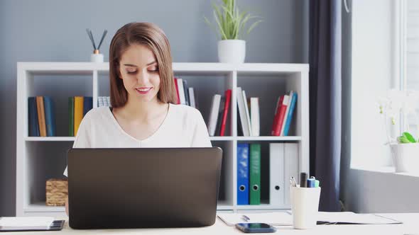 Young Woman Works at Home Office Using Computer.