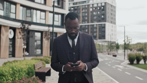 African-American Businessman Walking and Using Phone