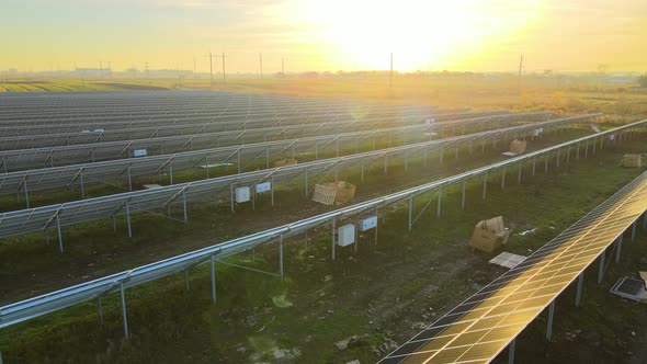 Aerial view of solar power plant under construction on green field. Assembling of electric