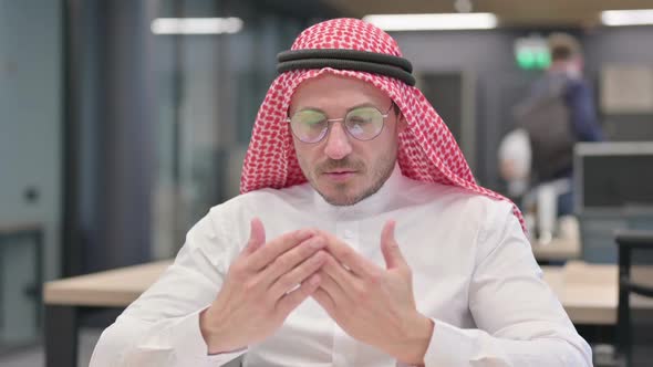 Middle Aged Arab Man Praying with Hands Raised