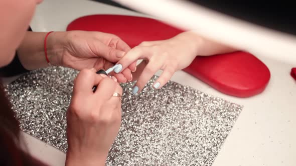 Closeup Video of Professional Manicure Master Using Nail Small Brush