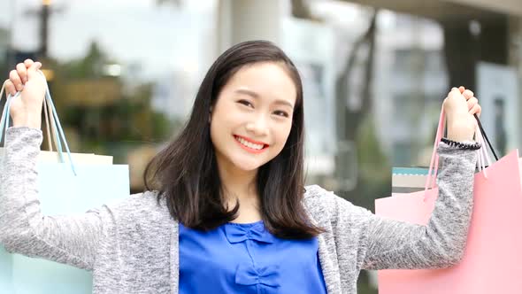 Woman holding shopping bags enjoying spending money