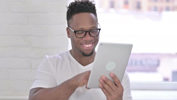 Portrait of Serious Casual African Man Using Tablet