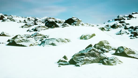 Snowy Mountains and Dark Rocks