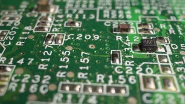 Extreme Closeup of Green Printed Circuit Board Electronics Shot with Dolly