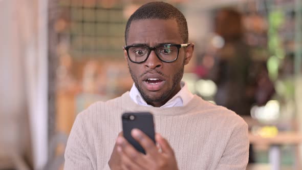 Portrait of Upset African Man Having Loss on Smartphone 