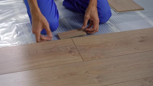 A Man Professional Laminate Installer Laying Laminate Wood