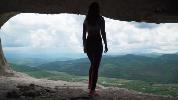 Girl Traveler Walks Through Cavern. Cave City in Vicinity of Bakhchisarai - Tope Kermen in Crimea