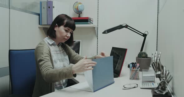 Office Worker Sitting at Her Desk