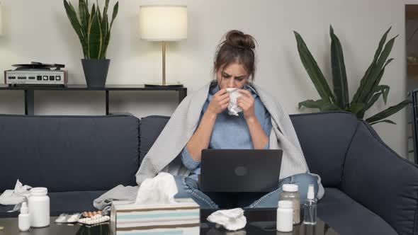 Sick Young Woman with Laptop Working at Home