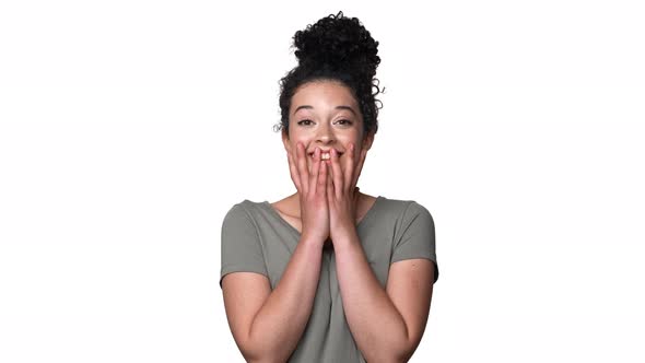 Portrait of Young Curly Woman 20s Expressing Surprise and Excitement While Covering Open Mouth with