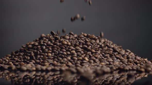 Roasted Coffee Beans Pouring on Heap Close Up