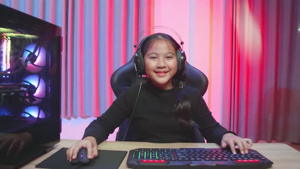 Asian Young Woman Controlling Console With Mouse And Keyboard Win Video Game