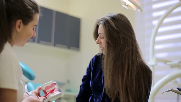 Close up of dental equipment in hospital with patient lying on exam chair and dentist working.