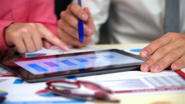 Businesspeople Examining Business Charts