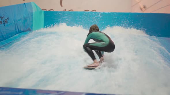 Child and Instructor at Flow Rider Indoor Surfing Training Session