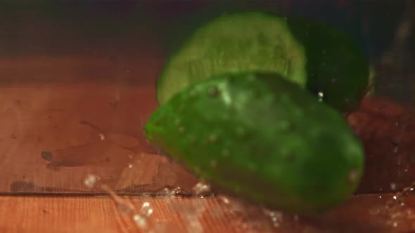 Super Slow Motion Fresh Cucumber Cut with a Knife Into Two Halves