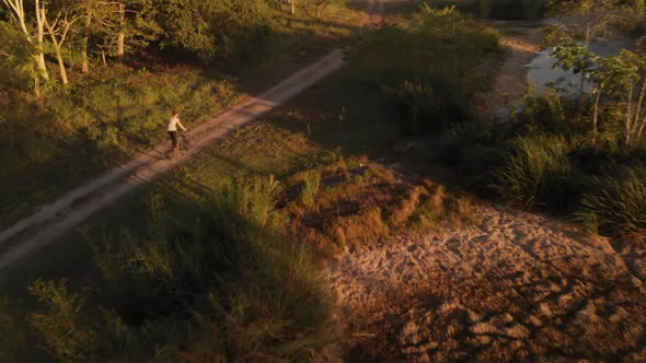 Aerial Flight Woman Rides Bike On The Nature