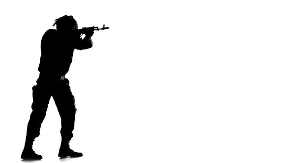Man Dressed in Camouflage Clothes. Silhouette