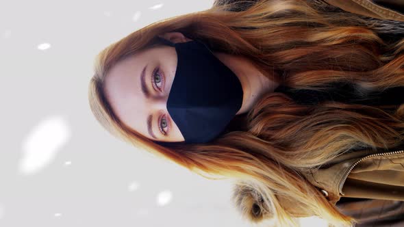 Woman Wearing Reusable Protective Mask in Winter