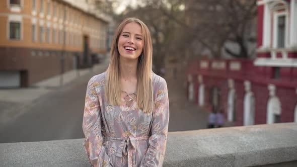 Portrait of Seductive Cheerful Woman 20s with Blond Hair Wearing Dress Laughing While Standing on