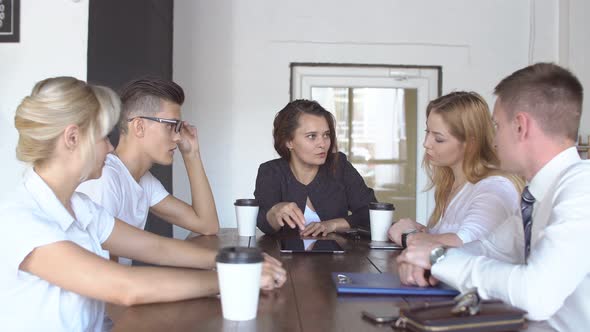 Group of Friends with Laptop Planning New Business at Cafe