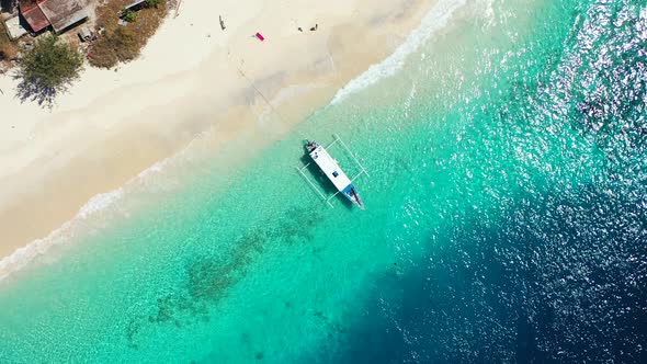 White kayak standing on the sandy shore and the seafront white waves splashing in paradise island Ph