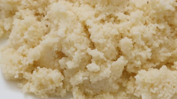 Freshly cooked couscous served on the plate slow tilt close-up 4K 3840X2160 30fps UHD video - Tasty 