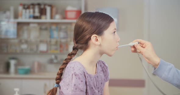 Female doctor checking a young girl in the clinic