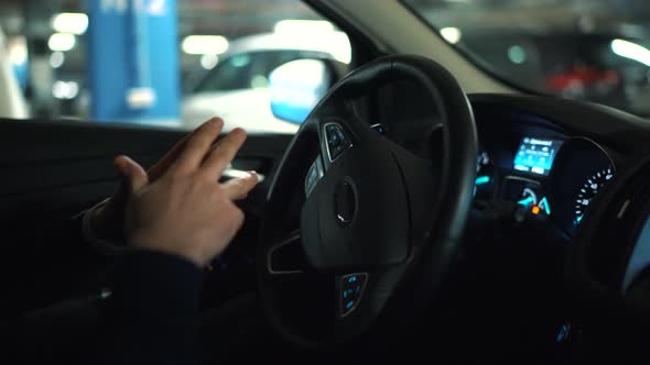 Man Driving in Innovative Automated Car Using Selfparking Autopilot for Parking on Street