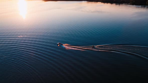 Motor boat on water at sunset