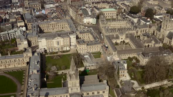 Pan up drone shot over old Oxford University buildings city centre