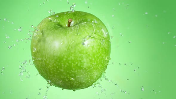 Super Slow Motion Shot of Fresh Green Apple Falling Into Water at 1000Fps.