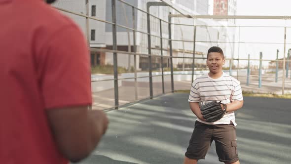 Father and Son Training Baseball Outdoors
