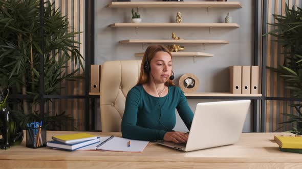 Young Woman Wear Headset Communicating By Conference Call Speak Looking