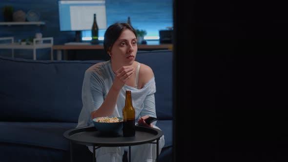 Emotional Young Woman Eating Popcorn While Watching Disgusting Tv Movie