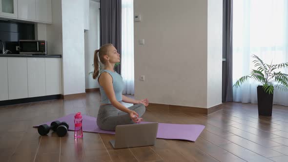 Woman Having Online Workout with Trainer on Laptop