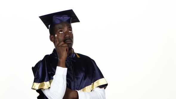 Graduate Holding a Finger at a Face and Thinks. White. Close Up