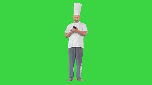 Male Chef Making a Video Call on Smartphone on a Green Screen Chroma Key