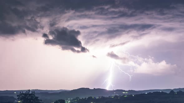 Dramatic thunderstorm with lightning discharge and rain over the hills