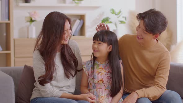 Little girl told happiness story to her mom and dad with positive and proud emotional.Asian Daughter