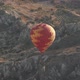 Red and Orange Hot Air Balloon Flies Over Fantastic Highland - VideoHive Item for Sale