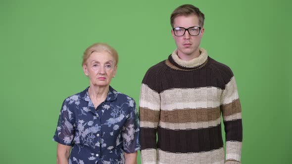 Grandmother and Grandson Together Against Green Background