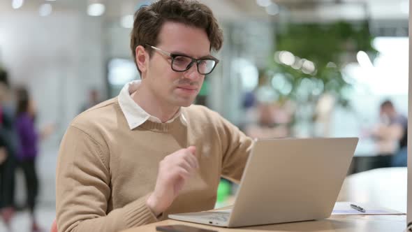 Young Male Designer Having Wrist Pain While Working on Laptop